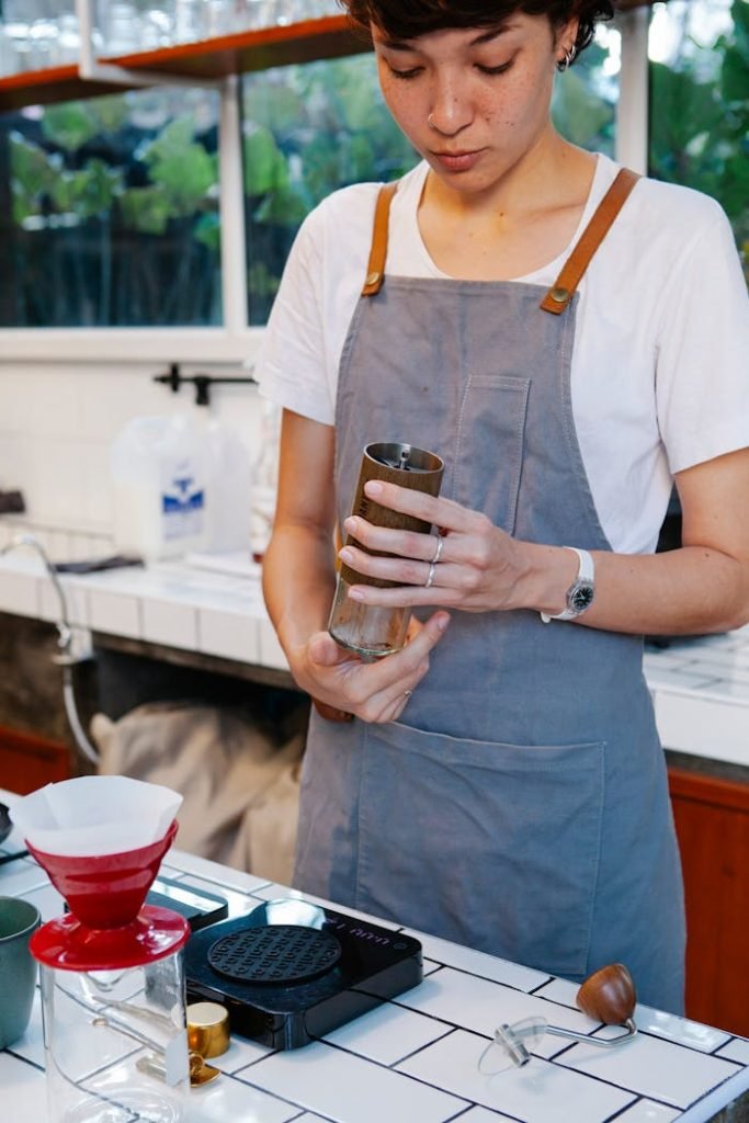 A barista prepares filter coffee with precision. Ideal for café or coffee business themes.
